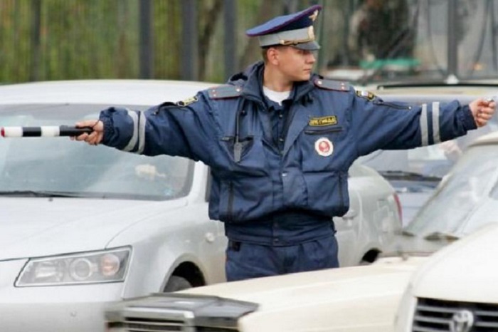 Регулировщик держит руки в стороны